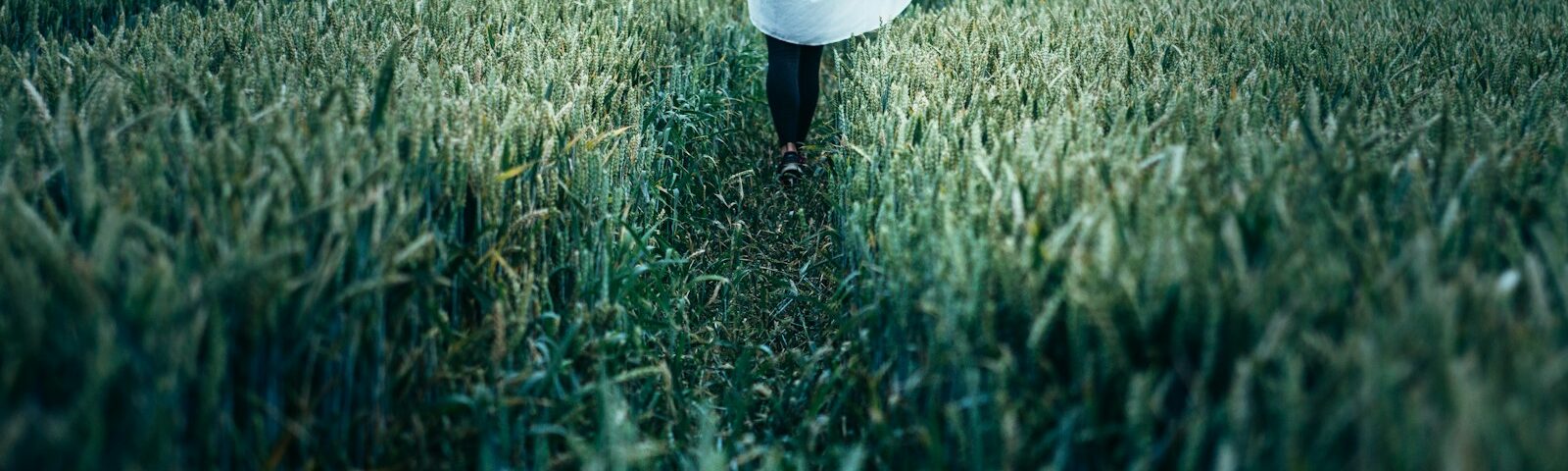 woman walking on grass field