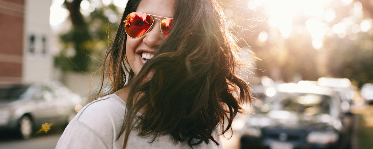 woman wearing white T-shirt smiling