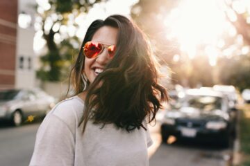 woman wearing white T-shirt smiling